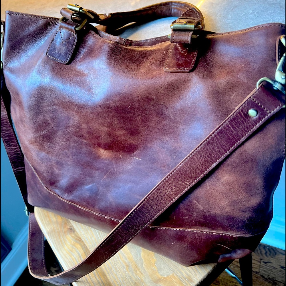 Large brown leather handbag tote, with handles and Crossbody strap.